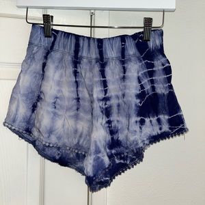 Cute tie dye shorts with Pom poms on leg opening